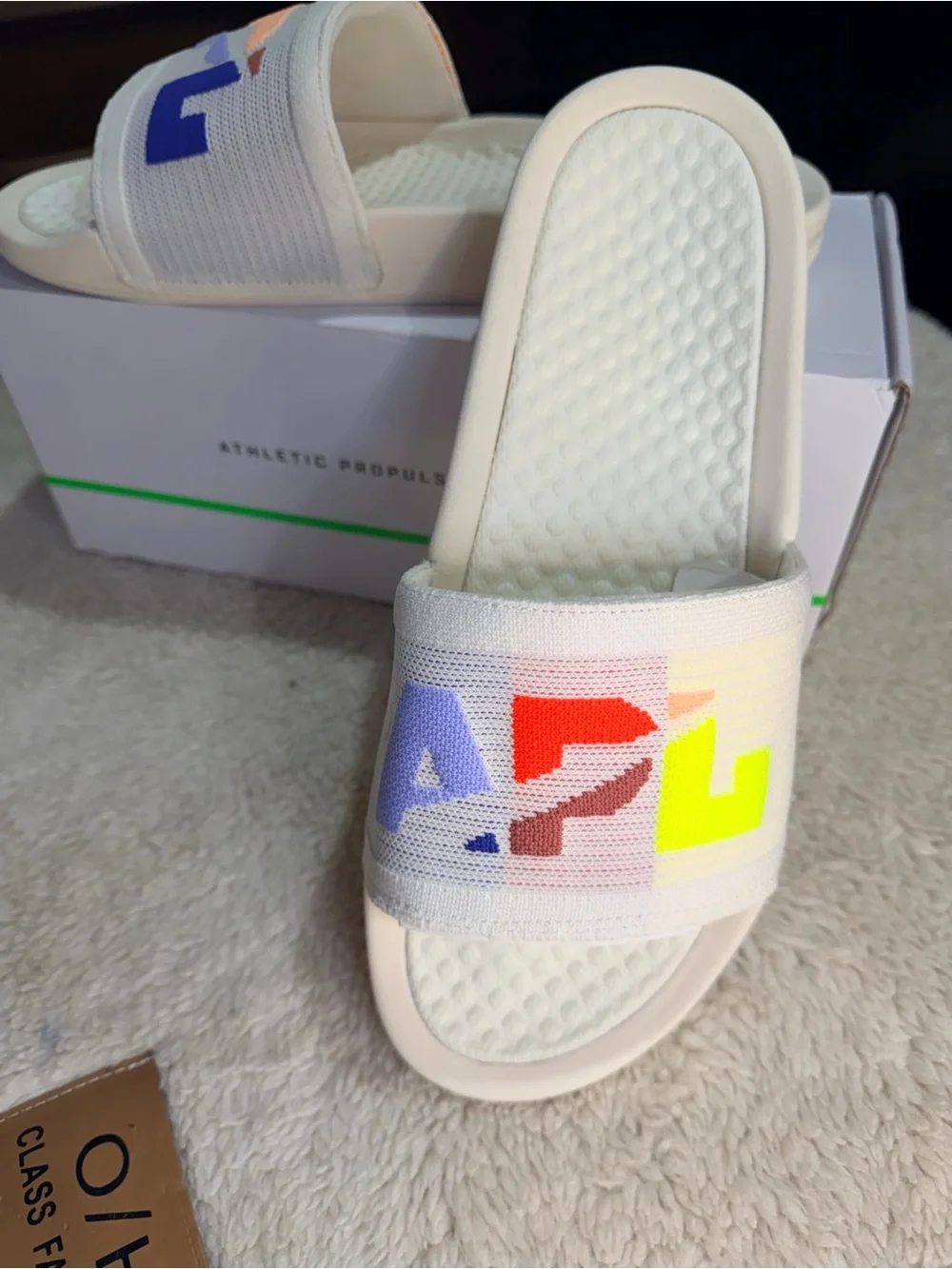 986. NIB SIZE M/9-W/10.5 APL Cream Slide Sandals with Multicolor Logo Accents
